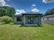 Newly built home with a spacious backyard and covered patio at 213 Cordova Rd, Auburndale, FL 33823