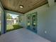 Covered patio with wood ceiling and backyard view at 213 Cordova Rd, Auburndale, FL 33823