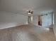 Large main bedroom with ceiling fan and access to the bathroom at 213 Cordova Rd, Auburndale, FL 33823