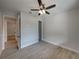 Bright bedroom with ceiling fan, wood-look tile floor, and access to another room at 213 Cordova Rd, Auburndale, FL 33823