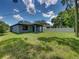 House with backyard and partial view of neighborhood at 213 Cordova Rd, Auburndale, FL 33823