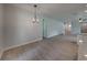 Bright dining room with wood-look floors and overhead lighting at 213 Cordova Rd, Auburndale, FL 33823