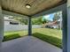 Covered patio with view of backyard and neighbor's home at 213 Cordova Rd, Auburndale, FL 33823