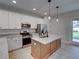 Modern kitchen with island, stainless steel appliances, and granite countertops at 213 Cordova Rd, Auburndale, FL 33823