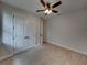Spacious bedroom with double doors and wood-look tile floors at 213 Cordova Rd, Auburndale, FL 33823