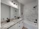Bathroom with granite countertop, double vanity, and marble shower at 213 Cordova Rd, Auburndale, FL 33823