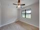 Spacious bedroom with wood-look tile flooring and a ceiling fan at 213 Cordova Rd, Auburndale, FL 33823