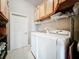 Laundry room with washer, dryer, and cabinets at 2505 Salzburg Loop, Winter Haven, FL 33884