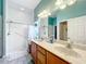 Bathroom with double vanity, walk-in shower, and tile flooring at 2505 Salzburg Loop, Winter Haven, FL 33884