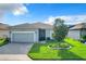 Gray house with a two-car garage and a landscaped yard at 2505 Salzburg Loop, Winter Haven, FL 33884
