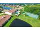 Aerial view of community with pool, tennis courts, and lake at 2505 Salzburg Loop, Winter Haven, FL 33884