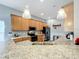 Modern kitchen with light wood cabinets, granite countertops, and stainless steel appliances at 2505 Salzburg Loop, Winter Haven, FL 33884