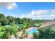Resort-style pool with tennis courts and lush landscaping at 2505 Salzburg Loop, Winter Haven, FL 33884