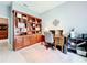 Home office with built-in wooden shelving and a large work desk at 2505 Salzburg Loop, Winter Haven, FL 33884