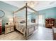 Spacious bedroom with a four-poster bed and access to the bathroom at 2505 Salzburg Loop, Winter Haven, FL 33884