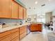 Open kitchen with granite countertops, light wood cabinets, and a breakfast bar at 2505 Salzburg Loop, Winter Haven, FL 33884