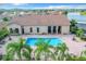 Community pool with surrounding patio and palm trees at 2505 Salzburg Loop, Winter Haven, FL 33884
