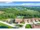 Community overview featuring homes, tennis court, and lake at 2505 Salzburg Loop, Winter Haven, FL 33884