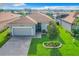Gray house with a two-car garage and manicured lawn at 2505 Salzburg Loop, Winter Haven, FL 33884