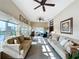 Sunroom with tiled floors, neutral-toned furniture, and abundant natural light at 2505 Salzburg Loop, Winter Haven, FL 33884