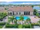 Community pool with surrounding patio and palm trees at 2505 Salzburg Loop, Winter Haven, FL 33884