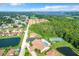 Aerial view of community, pool, tennis court and lake at 2505 Salzburg Loop, Winter Haven, FL 33884