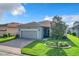 Gray house with a two-car garage and landscaped yard at 2505 Salzburg Loop, Winter Haven, FL 33884
