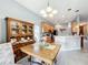 Bright dining room adjacent to the kitchen, featuring a wood table and hutch at 2505 Salzburg Loop, Winter Haven, FL 33884