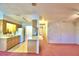 Kitchen features wood cabinets, pink carpet, and a breakfast bar at 317 C St, Lake Wales, FL 33853