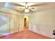 Spacious bedroom with ceiling fan and double door closet at 317 C St, Lake Wales, FL 33853