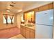 Basic kitchen with light wood cabinets, a double sink, and a view to dining area at 317 C St, Lake Wales, FL 33853