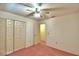 Bedroom with pink carpet, double door closet and access to another room at 317 C St, Lake Wales, FL 33853