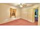 Bedroom with ceiling fan and window with curtains at 317 C St, Lake Wales, FL 33853