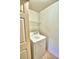 Practical laundry room with washer, dryer, and overhead shelving at 317 C St, Lake Wales, FL 33853