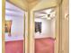 Hallway view of two bedrooms with pink carpet at 317 C St, Lake Wales, FL 33853