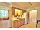 Efficient kitchen with light wood cabinets, a double sink, and access to laundry at 317 C St, Lake Wales, FL 33853