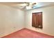 Bedroom with pink carpet, ceiling fan, and window with curtains at 317 C St, Lake Wales, FL 33853