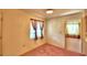 Cozy dining area with pink carpet, a window with curtains, and an exterior door at 317 C St, Lake Wales, FL 33853