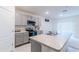 Kitchen with gray cabinets, island, and stainless steel appliances at 460 Boardwalk Ave, Haines City, FL 33844
