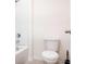 Bathroom with white toilet and tub at 460 Boardwalk Ave, Haines City, FL 33844