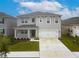 Two-story house with gray siding and two-car garage at 460 Boardwalk Ave, Haines City, FL 33844