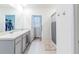 Bathroom with double vanity, shower, and walk-in closet at 460 Boardwalk Ave, Haines City, FL 33844