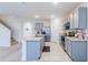 Modern kitchen with gray cabinets, stainless steel appliances, and an island at 460 Boardwalk Ave, Haines City, FL 33844