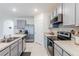 Modern kitchen with gray cabinets and stainless steel appliances at 460 Boardwalk Ave, Haines City, FL 33844
