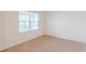 Bright bedroom with carpeted floors and large window at 460 Boardwalk Ave, Haines City, FL 33844