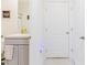 Grey vanity and white door, next to a bathroom at 460 Boardwalk Ave, Haines City, FL 33844