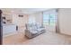 Living room featuring a comfortable light grey reclining sofa and access to backyard at 460 Boardwalk Ave, Haines City, FL 33844