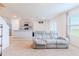 Living room with a light grey reclining sofa and view into the kitchen at 460 Boardwalk Ave, Haines City, FL 33844