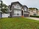 Two-story home with gray siding, two-car garage and landscaping at 5219 Mystic Point Ct, Orlando, FL 32812