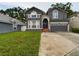 Two-story home with gray siding, two-car garage and landscaping at 5219 Mystic Point Ct, Orlando, FL 32812